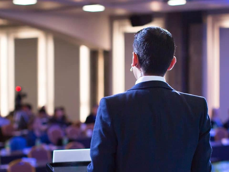 Conference speaker addressing business attendees